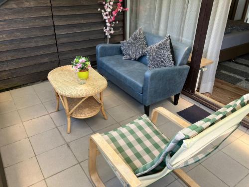 a patio with a couch and chairs and a table at Private Studio Apartment with Balcony in Dortmund-Brackel in Dortmund