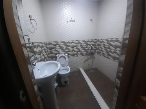 a small bathroom with a sink and a toilet at Shahina tur service in Samarkand