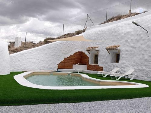 a rendering of a house with a swimming pool at Cueva OTTO Familiar Privada in Baza