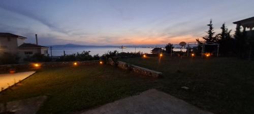 a view of a yard at night with lights at Lovely Stay in Kalamata