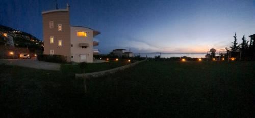 a building in a field at night with the sky at Lovely Stay in Kalamata