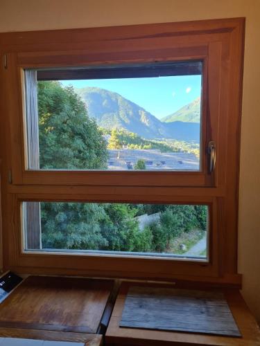 a window in a room with a view of a mountain at Apartment with view of Prorel in Briançon