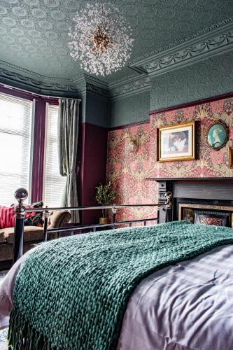 a bedroom with a bed and a chandelier at The Canoeists Hideaway in Seaton Carew