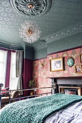 a bedroom with a bed and a chandelier at The Canoeists Hideaway in Seaton Carew