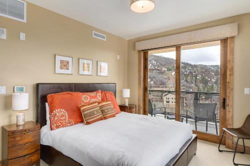 a bedroom with a bed and a large window at Edgemont 2602 - Luxury Ski-in Ski-out Condo in Steamboat Springs