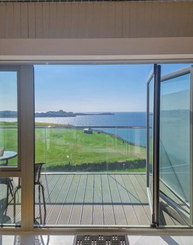 a balcony with a view of the ocean at Sea View Apartment at One Lusty Glaze in Newquay