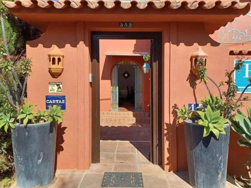 a small house with a door and plants in front of it at Villa Tiphareth in Marbella