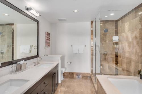 a bathroom with two sinks and a shower at Edgemont 2600 - Luxury Ski-in Ski-out Condo in Steamboat Springs