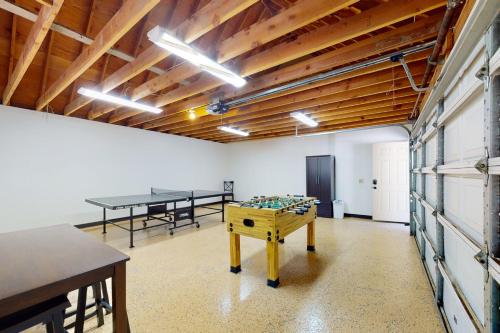 a room with two ping pong tables and ping pongamines at Rocky Pines in Twin Peaks