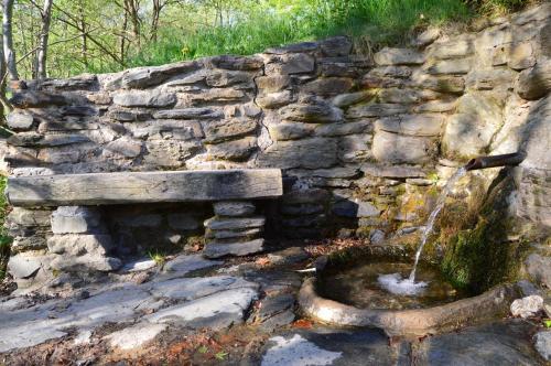 a stone wall with a water fountain at Hostal l'Escon in Llanars