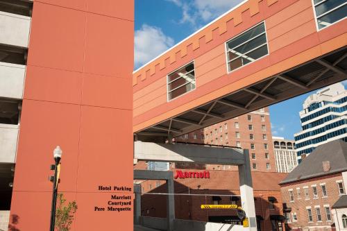 an orange building in a city with buildings at Courtyard Peoria Downtown in Peoria