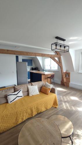 ein Wohnzimmer mit einem Sofa und einem Tisch in der Unterkunft Malo les bains Appt à 7 minutes de la plage in Dunkerque