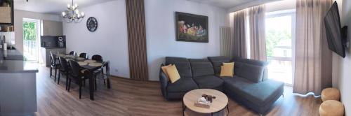 - un salon avec un canapé et une table dans l'établissement Apartament Olchowa Prestige 3, à Ustroń