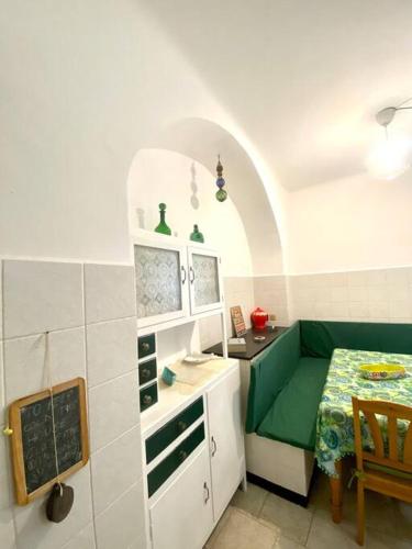 a kitchen with a green couch and a table at Appartamento nel cuore di Camogli 010007-LT-0594 in Camogli