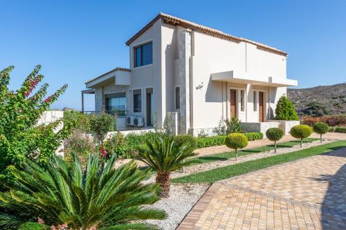 a villa with a view of the garden at Luxury Villa Hara with private pool in Agia Pelagia