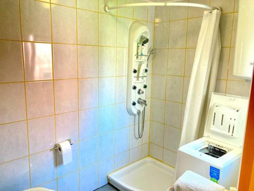 a bathroom with a shower with a phone on the wall at Relax house near Croatia in Piran