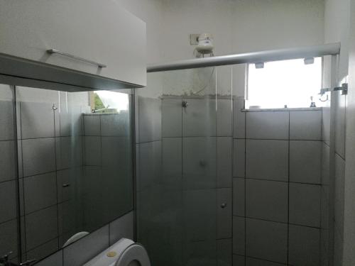 a bathroom with a shower and a toilet and a window at Apto em condomínio , portaria 24h, com área de lazer, ideal para famílias in Imperatriz
