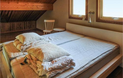 a large bed in a room with two pillows at 4 Bedroom Gorgeous Home In Frseke in Fröseke