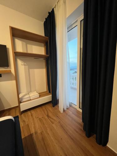 a room with a window with a view of the ocean at ILLYRIAN hotel Ksamil in Ksamil