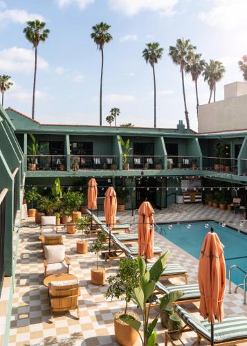 a view of the pool at the resort with orange umbrellas at Palihotel Hollywood near Universal Studios in Los Angeles