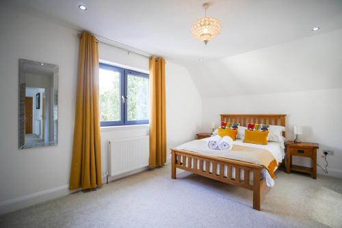 a bedroom with a bed with yellow curtains and a window at Pinewood Cottage Apartment & B&B Inverness in Inverness