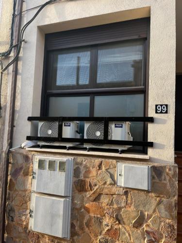 a window with two microwaves sitting on a ledge at ALOJAMIENTO LOS DINOSAURIOS in Cuenca
