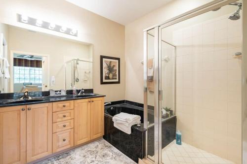 a bathroom with a shower and a sink at Luxury condo near Wiggins pass beach & park in Naples