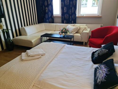 a living room with a bed and a couch at Pod Beczką in Augustów
