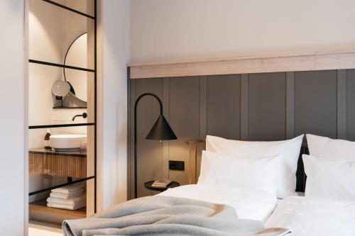 a bedroom with a bed with white pillows at Refugium Lunz in Lunz am See