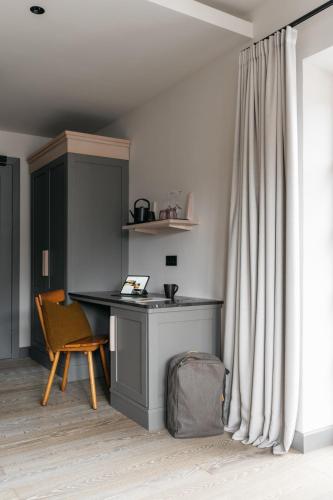 a desk and a chair in a room with a curtain at Refugium Lunz in Lunz am See