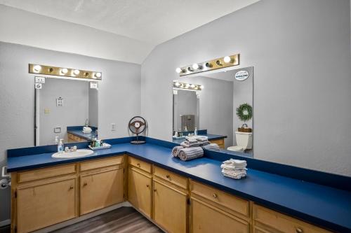 a bathroom with two sinks and a blue counter at Axtons Bass City Resort in Emory