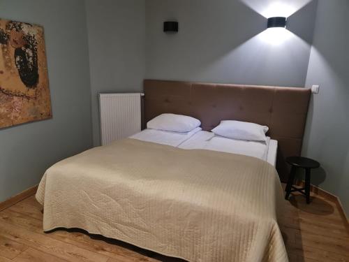 a bedroom with a bed with two pillows on it at Pod Beczką in Augustów