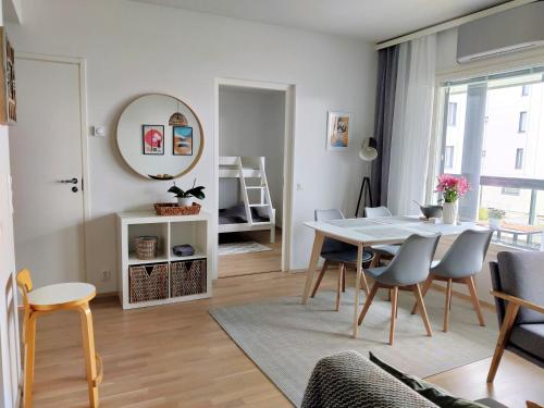 a living room with a dining room table and chairs at Toppilansalmi two bedroom apartment with a view in Oulu