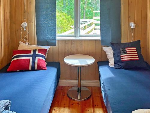 Zimmer mit 2 Betten und einem Tisch in der Unterkunft Holiday home VÄRMDÖ V in Värmdö