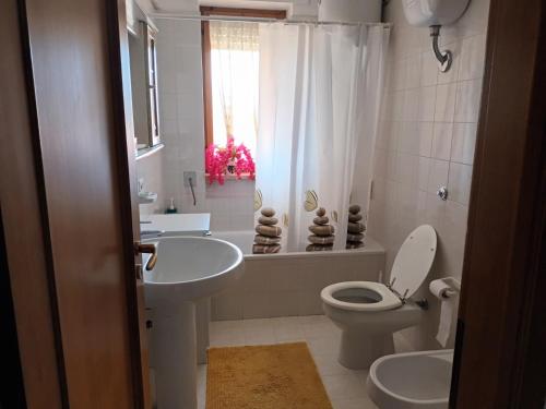 a bathroom with a sink and a toilet and a shower at Casa vacanza Gianna in Manduria