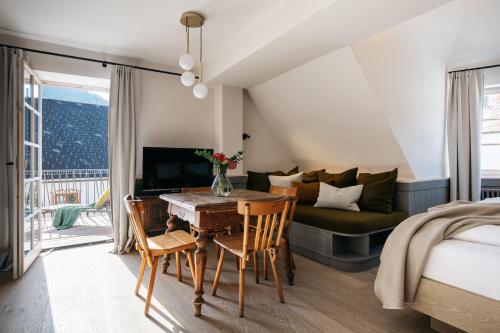 a bedroom with a bed and a table and a couch at Refugium Lunz in Lunz am See