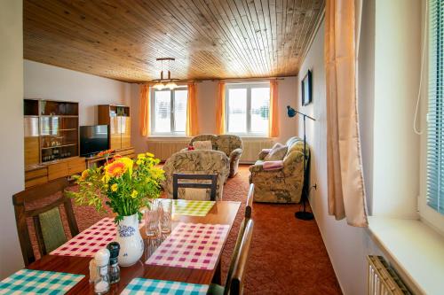 a dining room with a table and chairs at Chalupa Anežka in Frymburk
