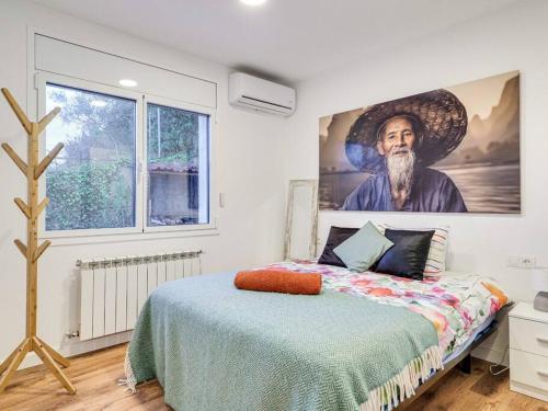 a bedroom with a painting of a man with a beard at V&VLLORET-VILLA CAMELIA gran villa para 12PAX, con aire acondicionado, piscina,casa árbol niños y ping-pong in Vidreres