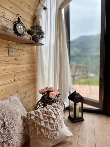 a room with a window with a clock on the wall at Woodhide - Cottages near Batumi, Georgia in Zeda Ch'khutunet'i