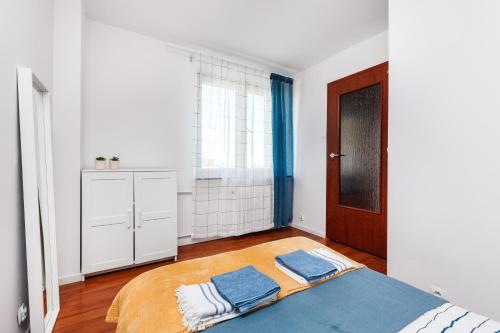 a white room with a bed and a window at Prime Home PORTOWY in Gdynia