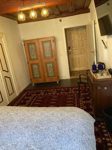 a bedroom with a bed and a desk and a door at Zur Baumwolle in Nürnberg