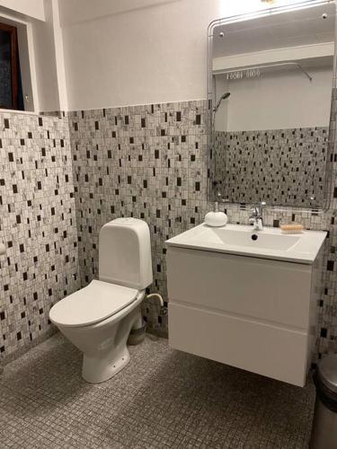 a bathroom with a toilet and a sink at beach room in Snogebæk