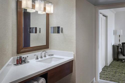 a bathroom with a sink and a mirror at Philadelphia Airport Marriott in Philadelphia