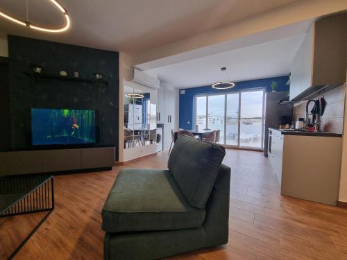 a living room with a couch and a fish tank at KORZO SUITES MSIDA LUXURY PENTHOUSE WITH POOL in Msida