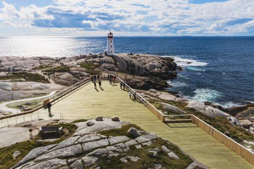 a lighthouse on the rocks near the ocean with people walking up the stairs at Holiday Inn Express & Suites Halifax Airport by IHG in Enfield