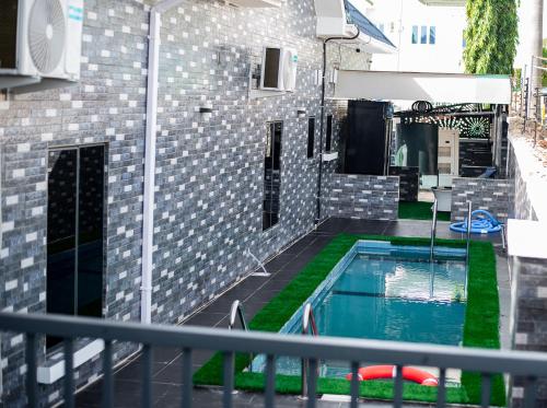 a balcony with a swimming pool next to a building at NIFEWAT APARTMENT,Dijon studio apartment with pool,WiFi, gym,Netflix and sit out area in Abuja
