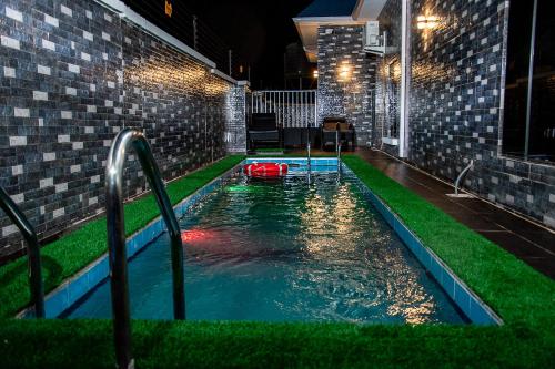 a swimming pool with a red ball in the water at NIFEWAT APARTMENT,Dijon studio apartment with pool,WiFi, gym,Netflix and sit out area in Abuja