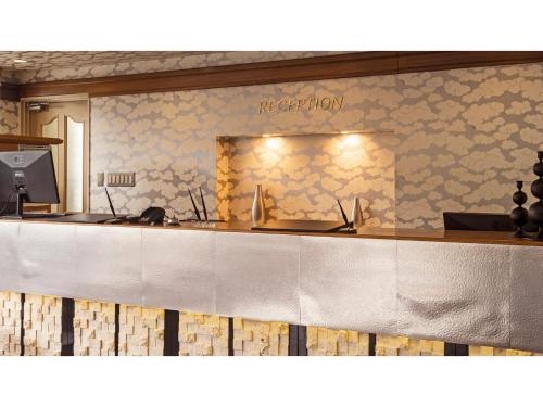 a reception counter in a restaurant with a sign on the wall at Hotel AreaOne Wadayama - Vacation STAY 10557v in Asago