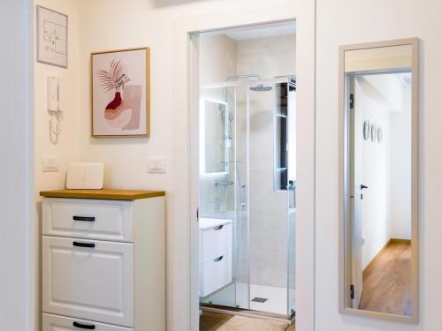 een badkamer met een douche en een wit dressoir bij Tonka Apartment in Pula