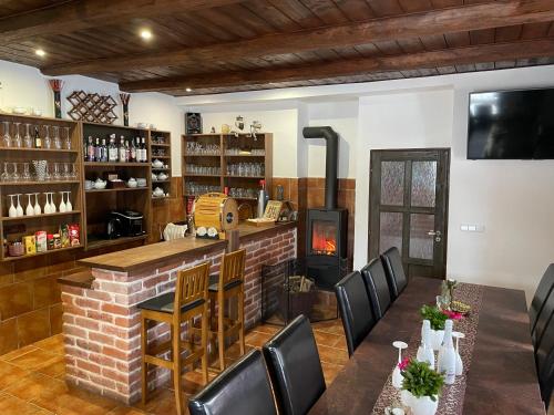 a restaurant with a bar and a fireplace at SG chalupa ŠTIKOV - Podkrkonoší - s celoročním privátním wellness in Nová Paka